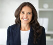 Portrait of cheerful attractive mature woman 50s wearing formal suit leader posing at office, smiling at camera. Closeup photo of happy business lady at workplace. Story of success, women in business
